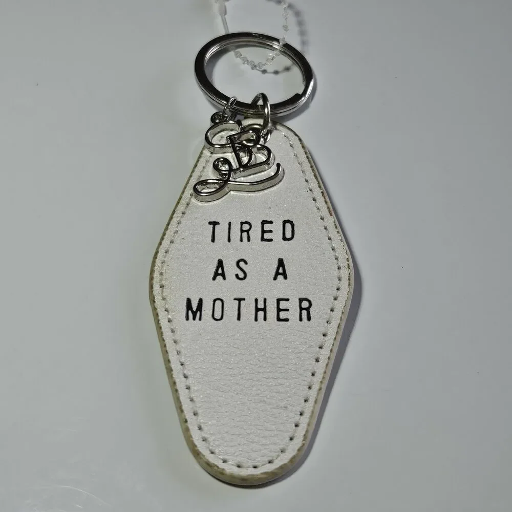 Santa Barbara Design Studio Silver Tone White Leather Tired As A Mother Keychain